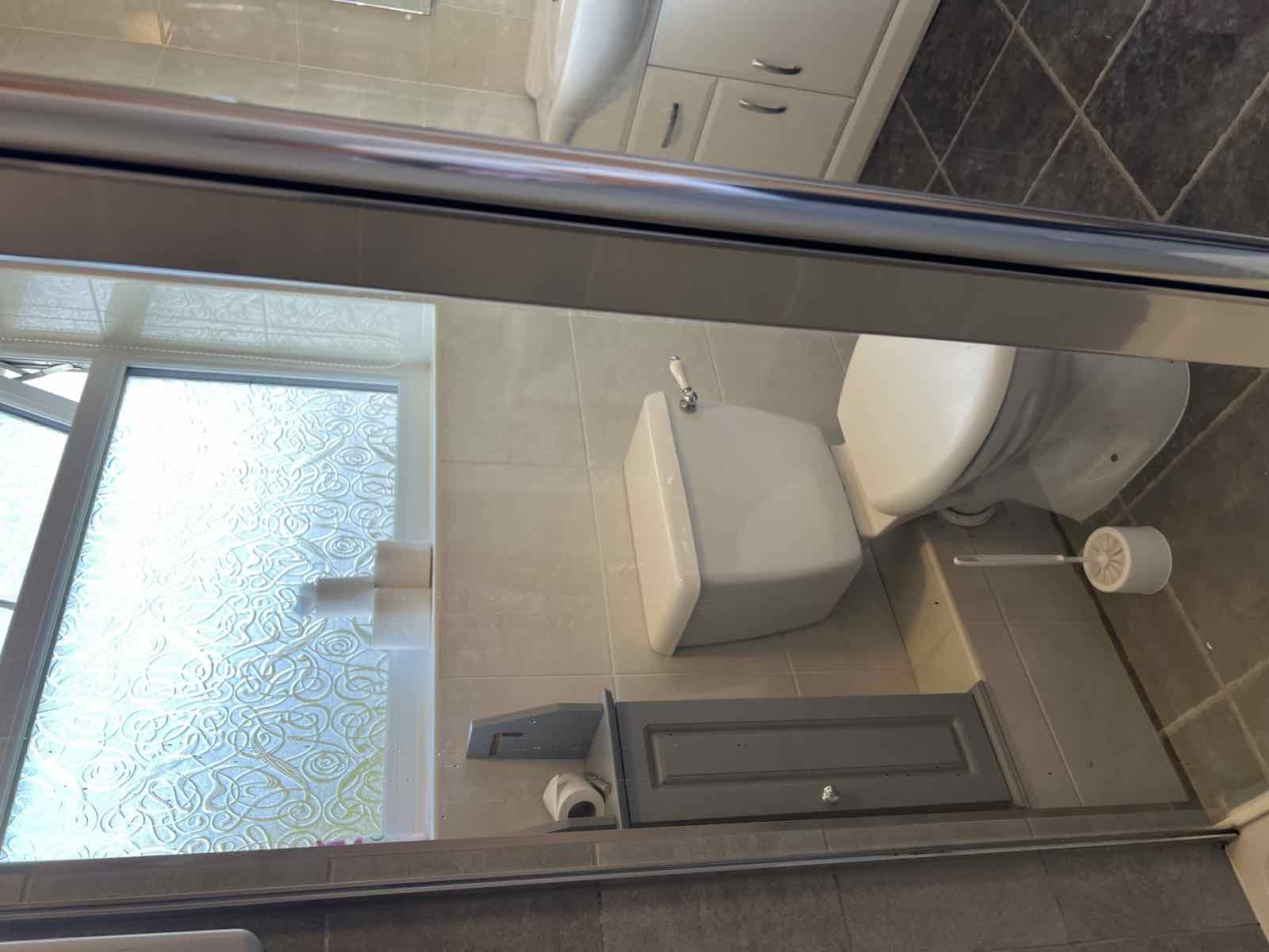 Tidied shower room toilet area after a clean