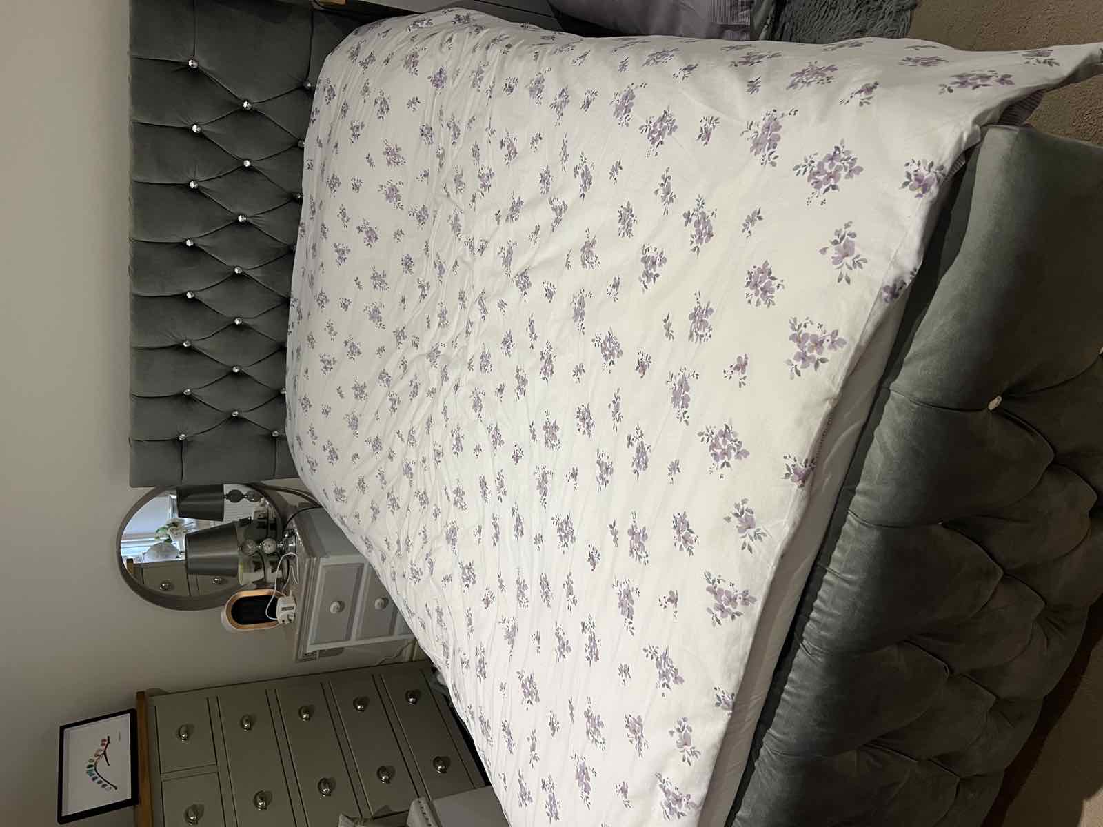 Neatly made double bed with floral bedspread, Boston