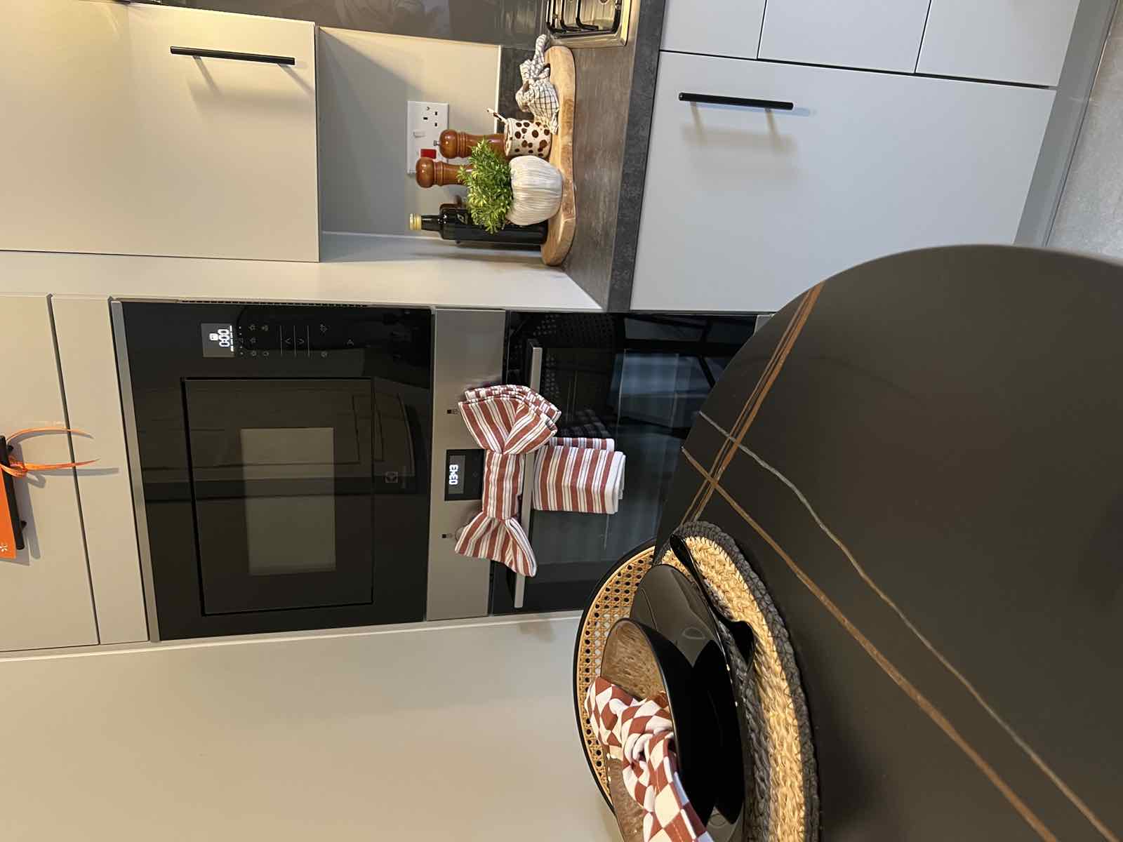 Tidied kitchen with microwave and dressed shelving, Boston